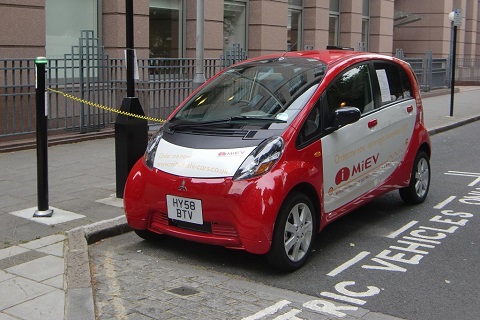 Mitsubishi i-MIEV parked at a street bay for electric vehicles