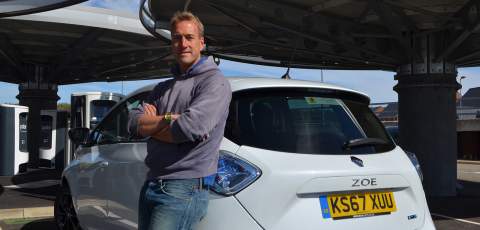 Ben leaning on a Renault Zoe