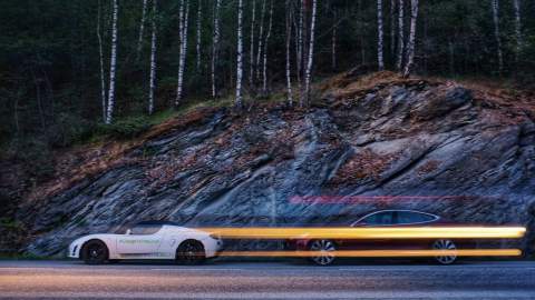 The Roadster driving past leaving a stream of light