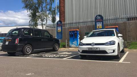 A Volkswagen and London Black Cab charging