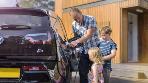 Family with a BMW i3 charging