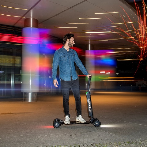  A man riding on an Audi e-tron scooter