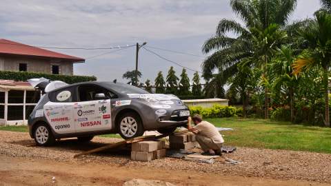 Repairing engine under its cover at Catholic Mission on Yaounde, Cameroon