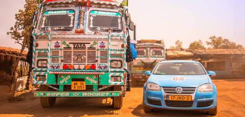 The Golf Estate next to a decorated van in India
