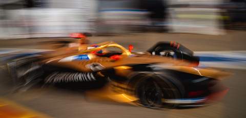 Blurred image of a Formula E car driving past