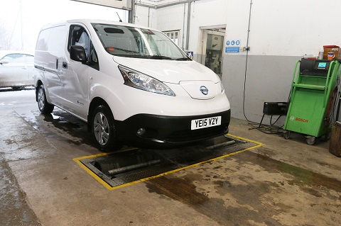 White Nissan at a servicing garage