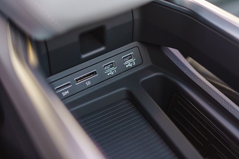 Interior close view on central console (usb and sim) of an Audi e-tron