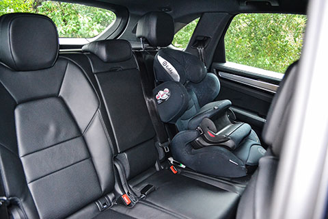 Porsche Cayenne E-Hybrid interior rear passenger seats with a child seat view