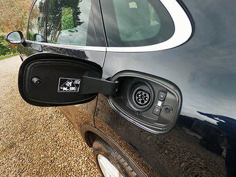 Porsche Cayenne E-Hybrid charging open flap exposing socket close view